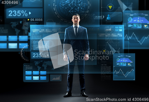 Image of businessman in suit over virtual screens