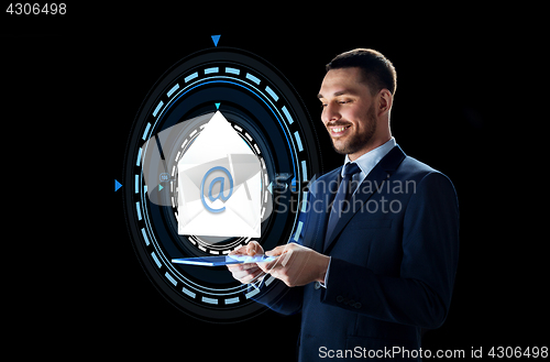 Image of businessman with tablet pc and e-mail hologram