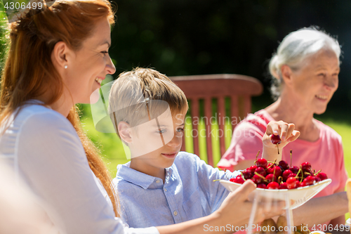 Image of happy family having dinner or summer garden party