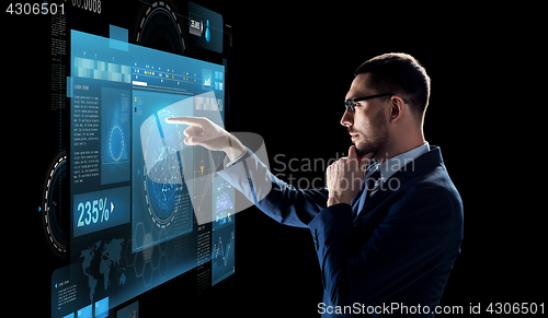 Image of businessman with virtual screen over black