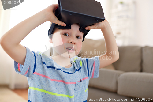 Image of little boy in vr headset or 3d glasses at home