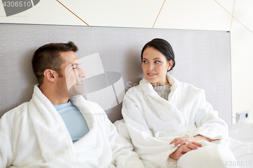 Image of happy couple in bed at home or hotel room