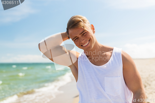 Image of smiling young man on summer beach