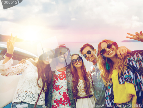 Image of hippie friends at minivan car showing peace sign