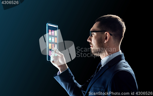 Image of businessman working with transparent tablet pc