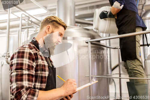 Image of men working at craft brewery or beer plant