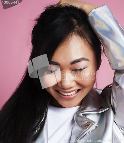 Image of young pretty smiling asian korean girl wearing modern fashion clothers on pink background, lifestyle people concept