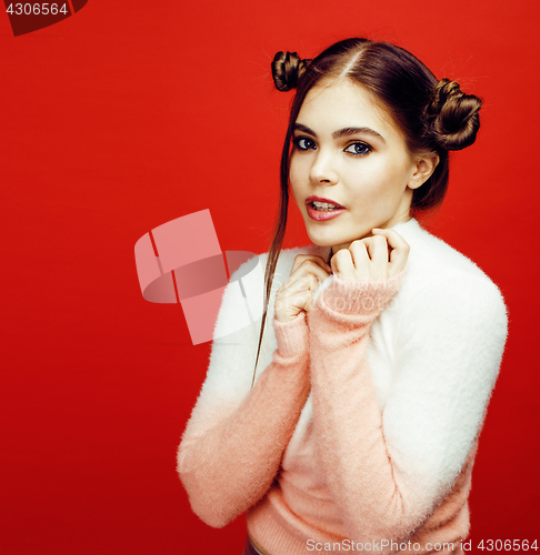 Image of young pretty emitonal posing teenage girl on bright red background, happy smiling lifestyle people concept 