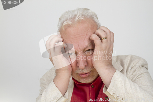 Image of Senior man with strong headache