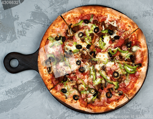 Image of Delicious Pizza with Ham, Olives and Jalapenos