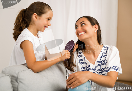 Image of Lelping mother brushing hair