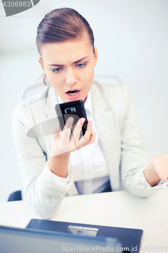 Image of woman shouting into smartphone