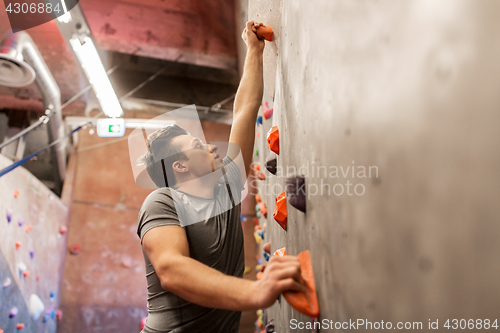 Image of young man exercising at indoor climbing gym