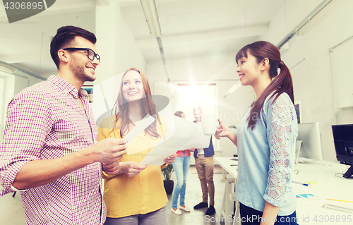 Image of creative team on coffee break talking at office