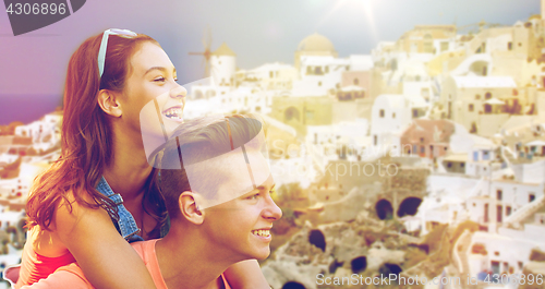 Image of happy teenage couple having fun on santorini