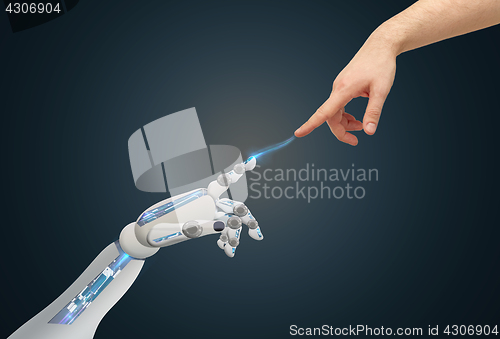 Image of human and robot hands reaching to each other