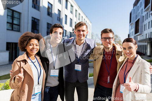 Image of business team with conference badges in city