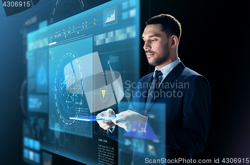 Image of businessman in suit with transparent tablet pc