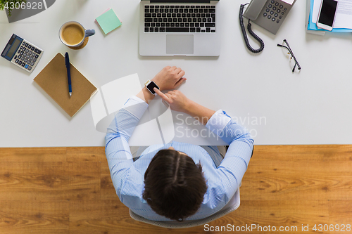 Image of businesswoman working on laptop at office