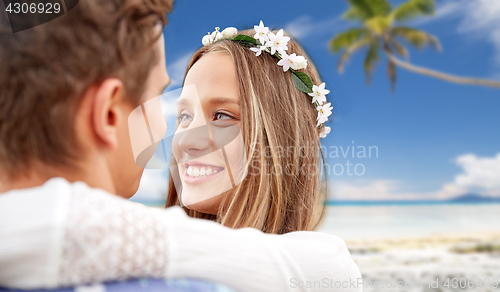 Image of happy smiling young hippie couple on summer beach