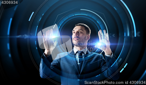 Image of businessman with virtual projection over black