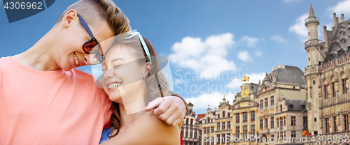 Image of happy teenage couple hugging in brussels city