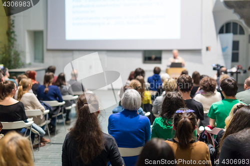 Image of Man giving presentation in lecture hall at university.