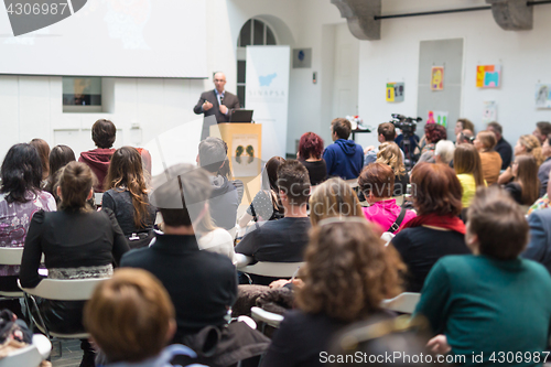 Image of Man giving presentation in lecture hall at university.