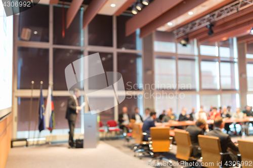 Image of Public speaker giving talk at Business Event.