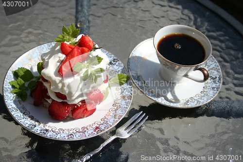 Image of Pastry with Swedish strawberries and a cup of strong coffee