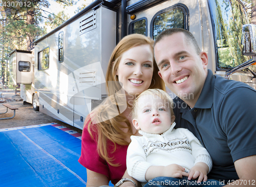 Image of Happy Young Military Family In Front of Their Beautiful RV At Th