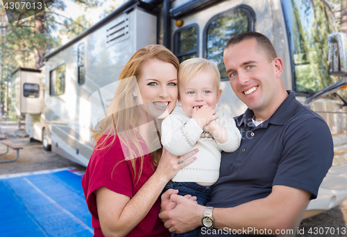 Image of Happy Young Military Family In Front of Their Beautiful RV At Th