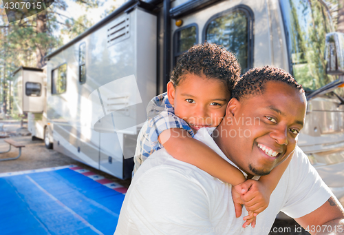 Image of African American Father With Mixed Race Son In Front of Their Be