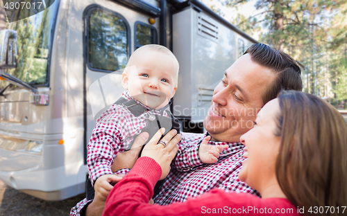 Image of Happy Young Caucasian Family In Front of Their Beautiful RV At T