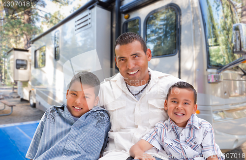 Image of Happy Hispanic Father and Sons In Front of Their Beautiful RV At