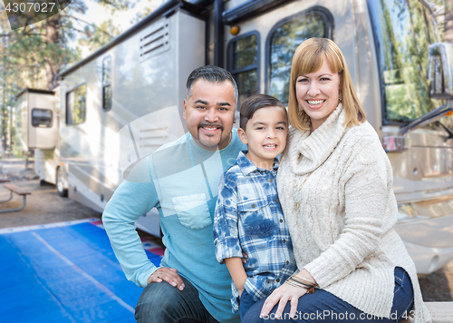 Image of Happy Young Mixed Race Family In Front of Their Beautiful RV At 