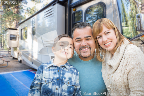 Image of Happy Young Mixed Race Family In Front of Their Beautiful RV At 