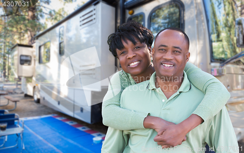 Image of Happy African American Couple In Front of Their Beautiful RV At 