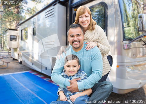 Image of Happy Young Mixed Race Family In Front of Their Beautiful RV At 