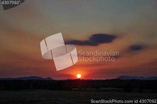 Image of Sunset with distant landscape