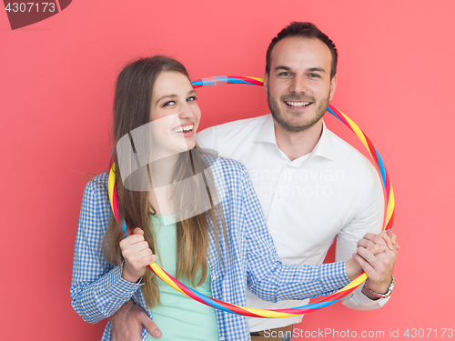 Image of portrait of happy couple with hula hoop