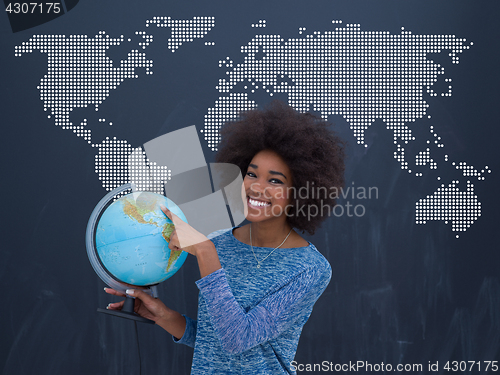 Image of black woman holding Globe of the world