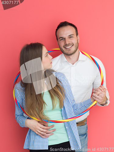 Image of portrait of happy couple with hula hoop