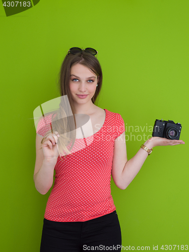 Image of smilling girl taking photo on a retro camera