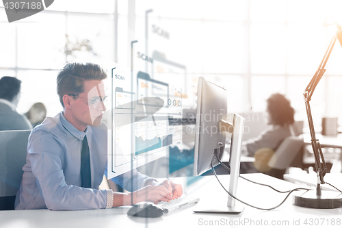 Image of businessman working using a computer in startup office