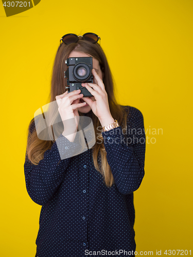 Image of young girl taking photo on a retro camera