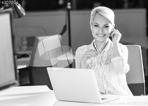 Image of Businesswoman using headset at work