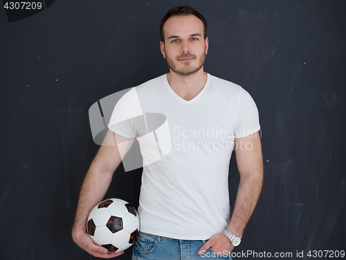 Image of man playing with soccer ball isolated over grey
