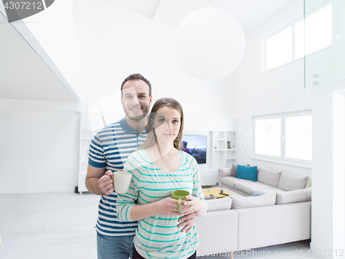 Image of young handsome couple enjoying morning coffee