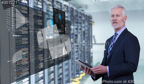 Image of Senior businessman in server room